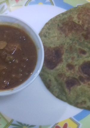 A picture of Methi ke parathe with aloo matar gravy.
