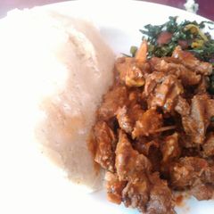 A picture of Ugali with fried beef and skuma.
