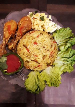 A picture of Veg and chicken biryani platter.
