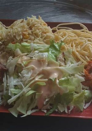 A picture of Coconut fried rice,spagetti with fried chicken and cabbage salad.