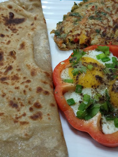 A picture of Half fry egg and mixed vegetables egg with paratha.
