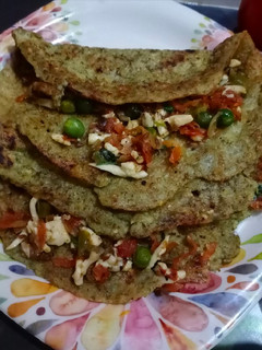 A picture of Green moong dal chilla with paneer stuffing.