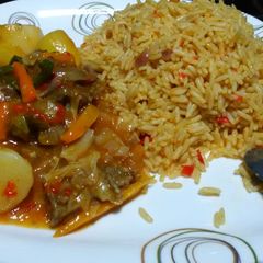 A picture of #jollofricecontest#jollof rice and beef gravy.