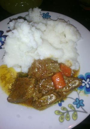 A picture of Beef stew and carrots.
