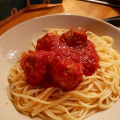 A picture of Easy peasy pork meat balls in a tomato sauce with spagetti.