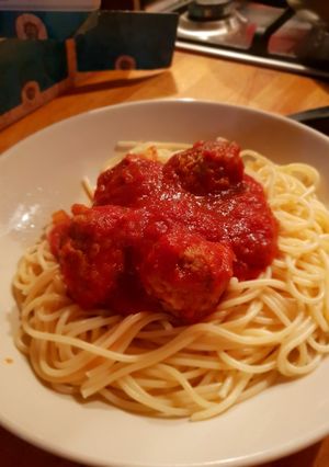 A picture of Easy peasy pork meat balls in a tomato sauce with spagetti.