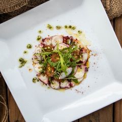 A picture of Octopus Salad with pepper dressing.