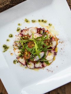 A picture of Octopus Salad with pepper dressing.