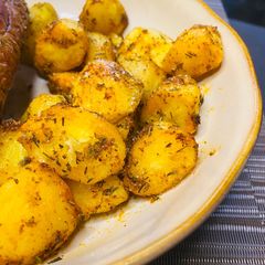 A picture of Crispy Garlic and Herb Air-fryer Potatoes.