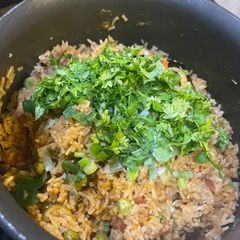 A picture of Tomato rice in pan.