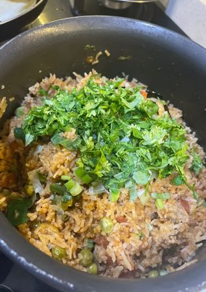 A picture of Tomato rice in pan.