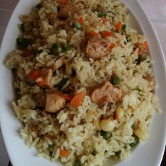 A picture of Chicken stir fry with rice and vegetables.