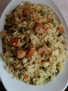 A picture of Chicken stir fry with rice and vegetables.