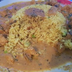 A picture of My Hot Chicken Curry around an island of special fried rice. 😀.