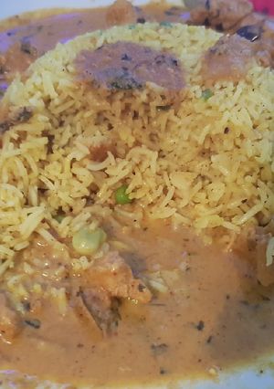 A picture of My Hot Chicken Curry around an island of special fried rice. 😀.