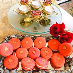 A picture of Red macaroons with golden heart#themechallenge.