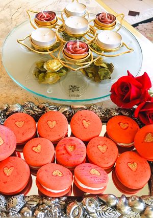 A picture of Red macaroons with golden heart#themechallenge.
