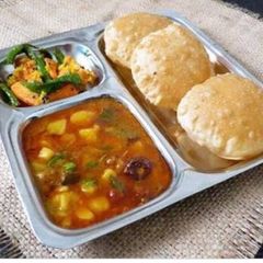 Puri and Aloo tomato curry A picture of Puri and Aloo tomato curry.