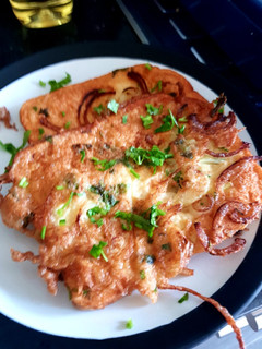 A picture of Egg'y bread with coriander and onion.