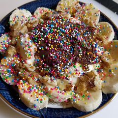A picture of Rainbow sprinkle ice cream sundae.