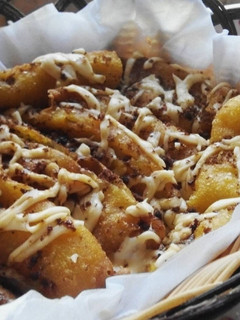 A picture of Fried Banana - with grated cheese and palm sugar on top.