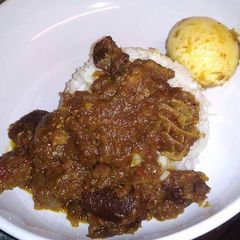 A picture of Ofada rice with egg and sauce.