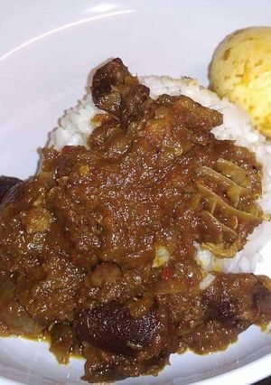 A picture of Ofada rice with egg and sauce.