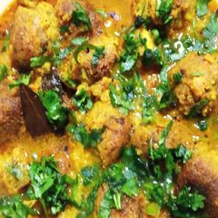 A picture of Kacha Kolar Kofta curry/ Plantain Kofta Curry.