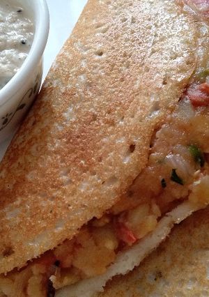 A picture of Masala Dosa with Coconut Chutney.