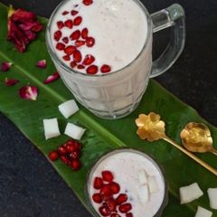 A picture of Pink Lassi For Summer ☀️ Lassi With Pomegranate Pearls And Coconut.