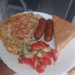 A picture of Simple breakfast... omelette,sausages,salad,bread.
