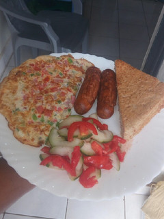 A picture of Simple breakfast... omelette,sausages,salad,bread.
