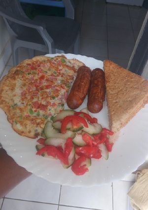 A picture of Simple breakfast... omelette,sausages,salad,bread.