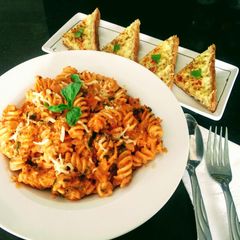 A picture of Pasta In Arabiata Sauce With Cheese Chilli Toast.