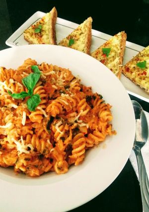 A picture of Pasta In Arabiata Sauce With Cheese Chilli Toast.