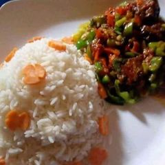 A picture of Rice with vegetable sauce.
