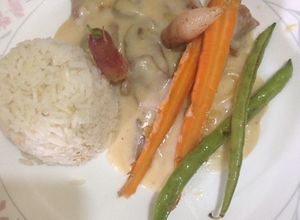 Una foto de Arroz con lomito de cerdo y champiñónes en salsa bechamel y vegetales bebe salteado con paprika