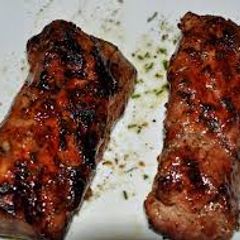 A picture of Grilled Pork Tenderloin with Pomegranate and Orange Glaze.