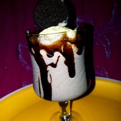 A picture of Oreo chocolate shake with icecream.