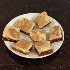 A picture of Fudge Brownies with Whipped White Chocolate Coffee Ganache Frost.