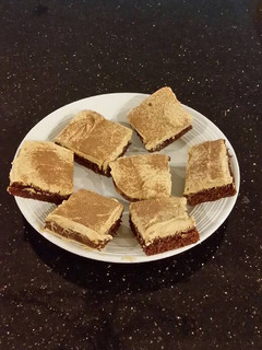 A picture of Fudge Brownies with Whipped White Chocolate Coffee Ganache Frost.