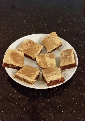 A picture of Fudge Brownies with Whipped White Chocolate Coffee Ganache Frost.