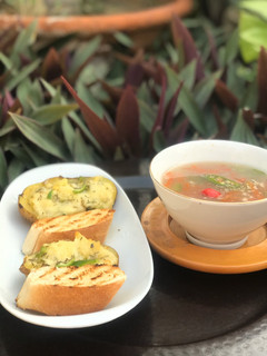 A picture of Thai vegetables soup with baked cheesy potatoes.
