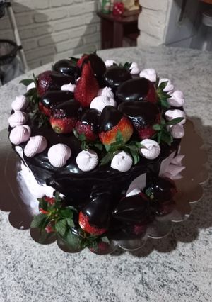 Una foto de Torta de chocolate con ganache de chocolate y frutillas 🍓