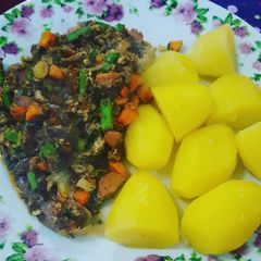A picture of Boiled potatoes with veggie sausage egg sauce.