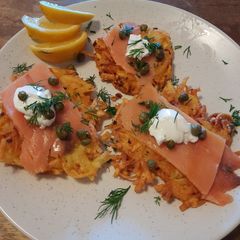 A picture of Potato pancakes with smoked salmon.