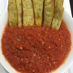A picture of Fried sweet potatoes and pepper sauce.