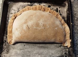 Una foto de Calzone de humita