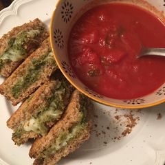 A picture of Low fat “grilled” cheese pesto sandwich and tomato soup.