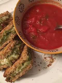 A picture of Low fat “grilled” cheese pesto sandwich and tomato soup.